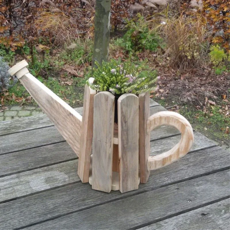 Wooden planter shaped like a watering can, with slatted boards, an angled spout and a curved handle.