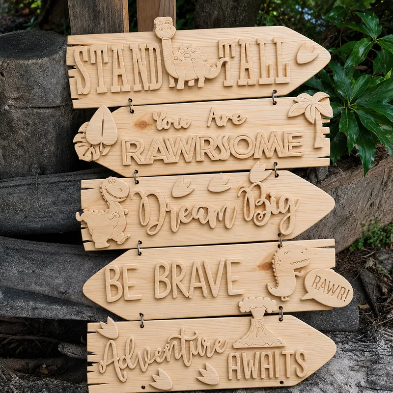Wooden arrow signs joined by rings, with raised dinosaur shapes and lettering.