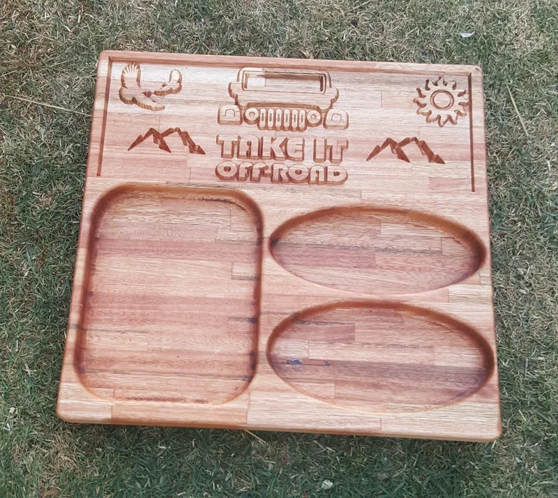 Square wooden braai board with three sunken serving wells and engraved 4x4, mountains and "Take It Off-Road" wording.